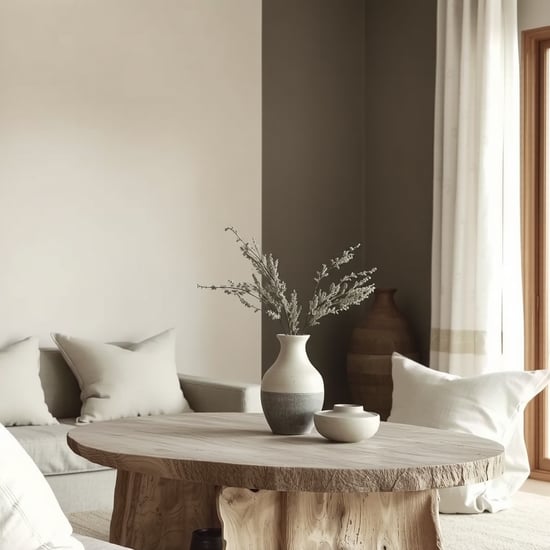 "Wabi-Sabi interior design, minimalist furniture, organic textures, muted color palette (beige, cream, grey), handmade ceramic vase, weathered wood table, asymmetrical decor, natural light, linen fabrics, imperfect pottery, earthy tones, quiet serenity, raw edges, muted greenery, subtle imperfections, tranquil space, monochrome details, slow living vibe"